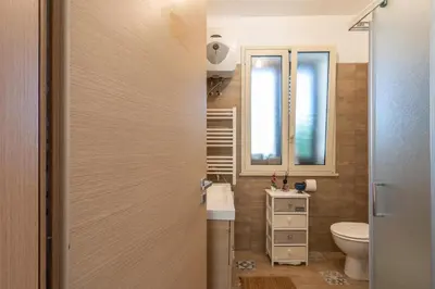 a bathroom with a toilet and a sink at Villa a due passi dal mare 