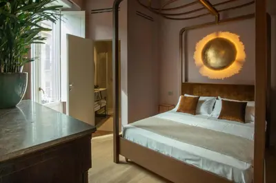 a bedroom with a bed and a large mirror at Gilded Age Luxury dream apartment historic center in Palermo