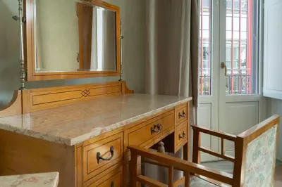 a bathroom with a wooden dresser with a mirror at Gilded Age Luxury dream apartment historic center in Palermo