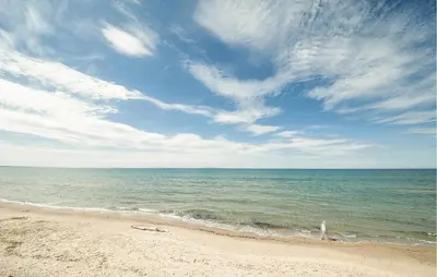 a beach with the ocean and a cloudy sky at Nice Apartment In Trappeto With Wifi in Trappeto