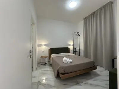 a bedroom with a bed with two pillows on it at BreMi Rooms B&B in San Vito lo Capo