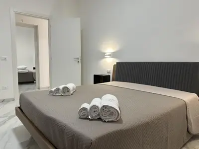 a bedroom with a bed with towels on it at BreMi Rooms B&B in San Vito lo Capo
