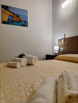 a bedroom with two beds with towels on them at Casetta Bianca Luxury in Santa Flavia