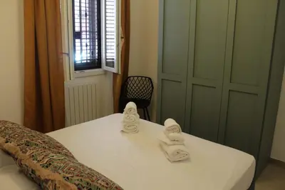 a bedroom with a bed with towels on it at Quiet House Palermo in Palermo