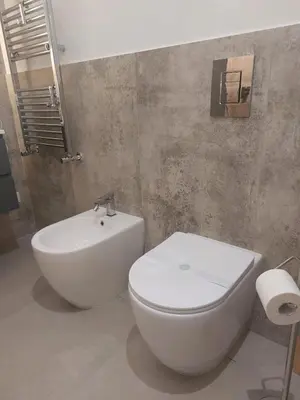 a bathroom with a white toilet and a sink at Quiet House Palermo in Palermo