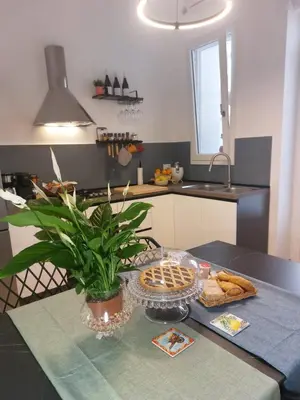 a kitchen with a table with a plate of bread at Quiet House Palermo in Palermo