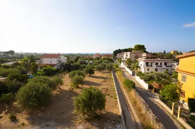 an aerial view of a town with trees and buildings at Bivio 281 suite&rooms in Carini