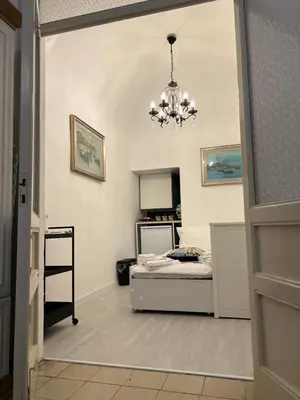 a bedroom with a bed and a chandelier at Appartamenti Tiffany & Timi in Carini