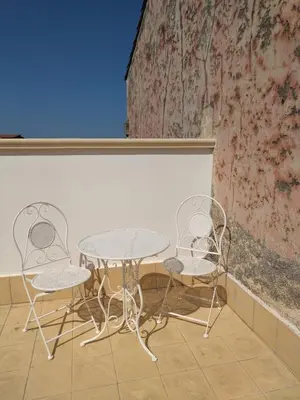 two chairs and a table and two tables and chairs at Antica Dimora Vaglica in Palermo