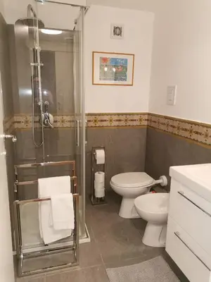 a bathroom with a shower and a toilet and a sink at Le case di Giù in Palermo