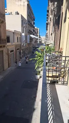 an empty street in a city with buildings at Le case di Giù in Palermo