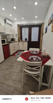 a kitchen with a table and a table and chairs at Casuzza del genio in Palermo