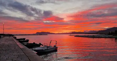 a group of boats in the water at sunset at Casuzza del genio in Palermo