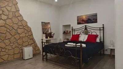 a bedroom with a bed with red pillows at Casuzza del genio in Palermo