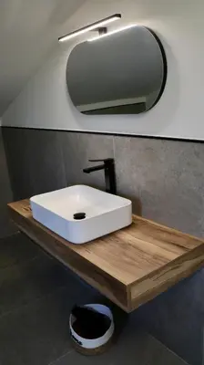 a bathroom with a white sink and a mirror at Villa Zagara modern villa with pool in Lascari
