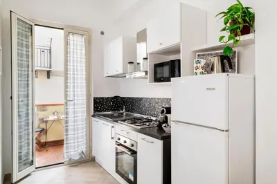 a kitchen with white appliances and a white refrigerator at Casa del Saraceno in Palermo