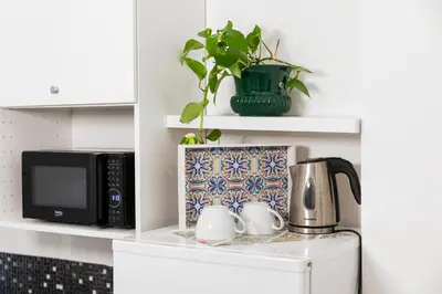 a kitchen counter with a microwave and a coffee pot at Casa del Saraceno in Palermo