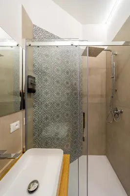 a bathroom with a glass shower with a sink at Bed & Theatre - Palermo in Palermo
