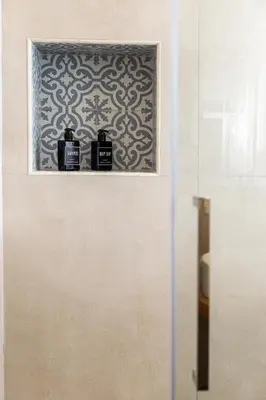 a bathroom with two bottles of soap on a shelf at Bed & Theatre - Palermo in Palermo