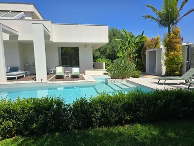 a villa with a swimming pool and a house at Domus Minerva in Palermo