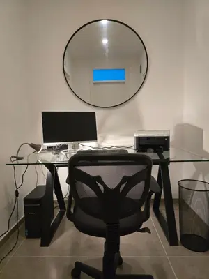 an office with a glass desk with a chair and a mirror at Domus Minerva in Palermo