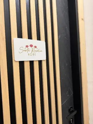 a sign on the side of a wooden door at santa Rosalia home in Palermo