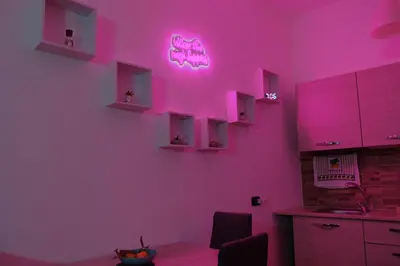 a kitchen with pink lights on the wall at Romantichouse in Palermo
