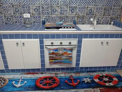 a blue tiled kitchen with a stove and a sink at lia&gio' in Campofelice di Roccella