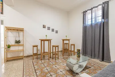 a living room with a glass table and chairs at Casa Florio Love Palermo in Palermo