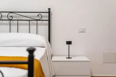 a bedroom with a bed and a lamp on a nightstand at Casa Florio Love Palermo in Palermo
