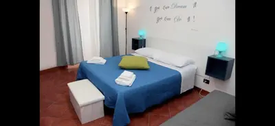 a bedroom with a bed with a green pillow and a tv at Casa vucciria in Palermo
