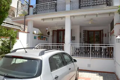 a white car parked in front of a house at Villa Eugenia - Mondello Beach in Palermo