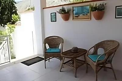 two chairs and a table in a room at Villa Eugenia - Mondello Beach in Palermo