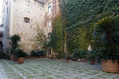 a building with plants on the side of it at Dimora Artale Suite in Palermo
