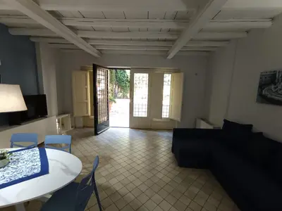 a living room with a couch and a table and chairs at Dimora Artale Suite in Palermo