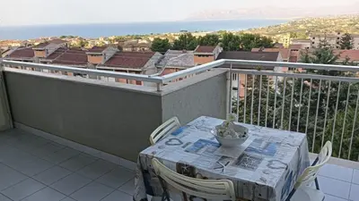 a table and chairs on a balcony with a view at Appartamento vista mare in Castellammare del Golfo