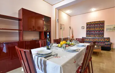 a dining room table with a white table cloth at Cozy Apartment In Trappeto With Wifi in Trappeto