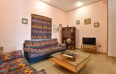 a living room with a couch and a coffee table at Cozy Apartment In Trappeto With Wifi in Trappeto