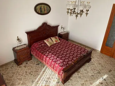 a bedroom with a bed and two night stands at Charming Historic Villa in Vita, Sicily - Your Home Away from Home in Vita