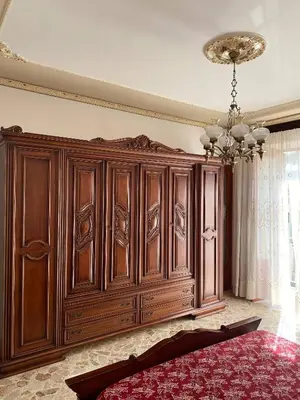 a large wooden cabinet in a room with a bed at Charming Historic Villa in Vita, Sicily - Your Home Away from Home in Vita