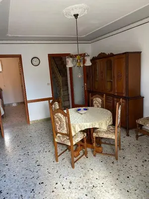 a dining room with a table and some chairs at Charming Historic Villa in Vita, Sicily - Your Home Away from Home in Vita