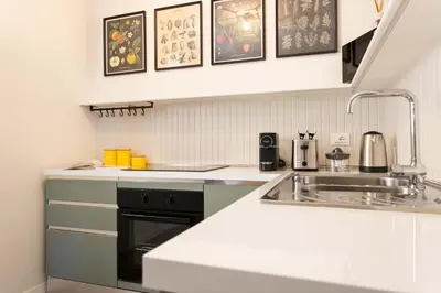 a kitchen with a sink and a counter top at Finestre sul Massimo - Centro Storico Palermo in Palermo