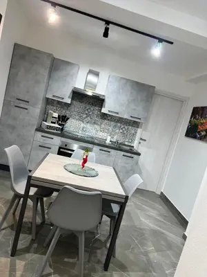 a dining room table and chairs in a kitchen at NR Apartment in Palermo