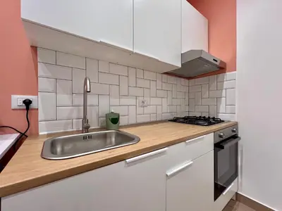 a kitchen with a sink and a stove at GiraSole in Palermo