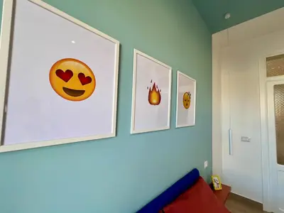 a room with three pictures on the wall at GiraSole in Palermo