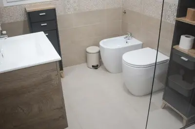 a bathroom with a toilet and a sink at Montalcini 3 in Capaci