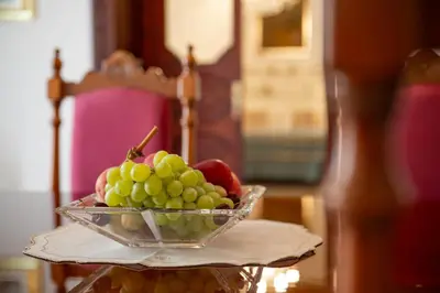 a bowl of grapes on a plate on a table at Artista Apartment in Alcamo