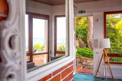 a room with a view of the ocean through a window at Solemar Sicilia - Villa Giovitto in Bagheria