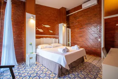 a bedroom with a bed and a brick wall at Solemar Sicilia - Villa Giovitto in Bagheria