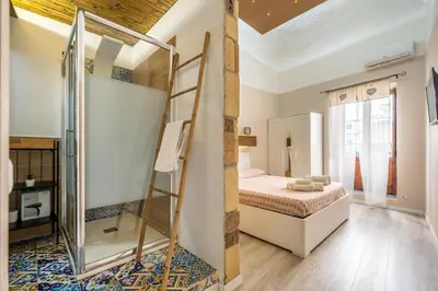 a bedroom with a bunk bed and a ladder at Historic soul apartment in Palermo